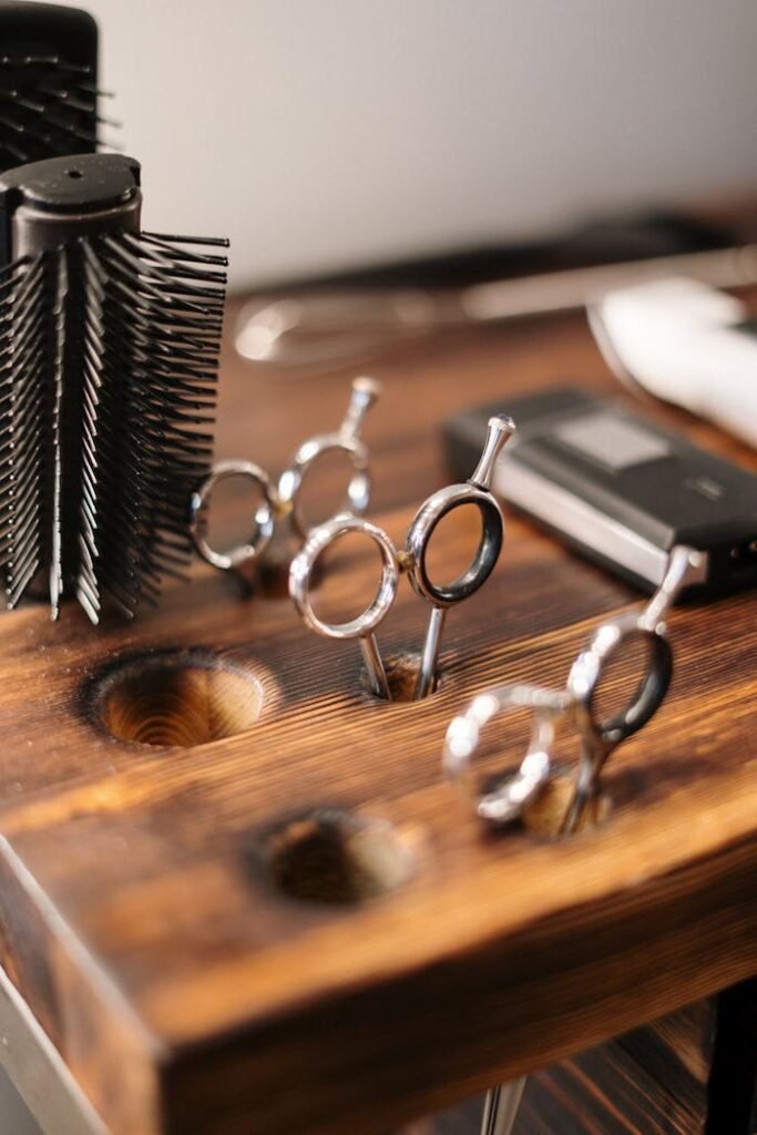 Close-up of professional hairdressing equipment on a wooden salon table, ready for use.