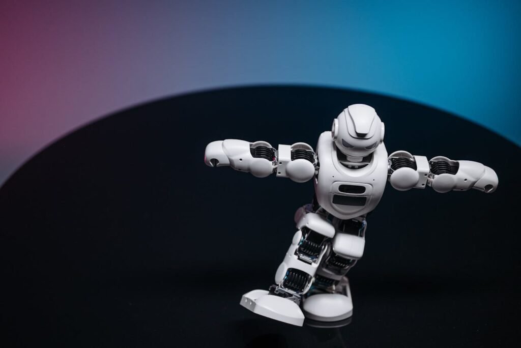 A futuristic white robot toy performing on a sleek dark surface.